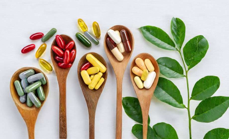variety vitamin pills wooden spoon white with green leaf supplemental healthcare products 1197119 1547 1